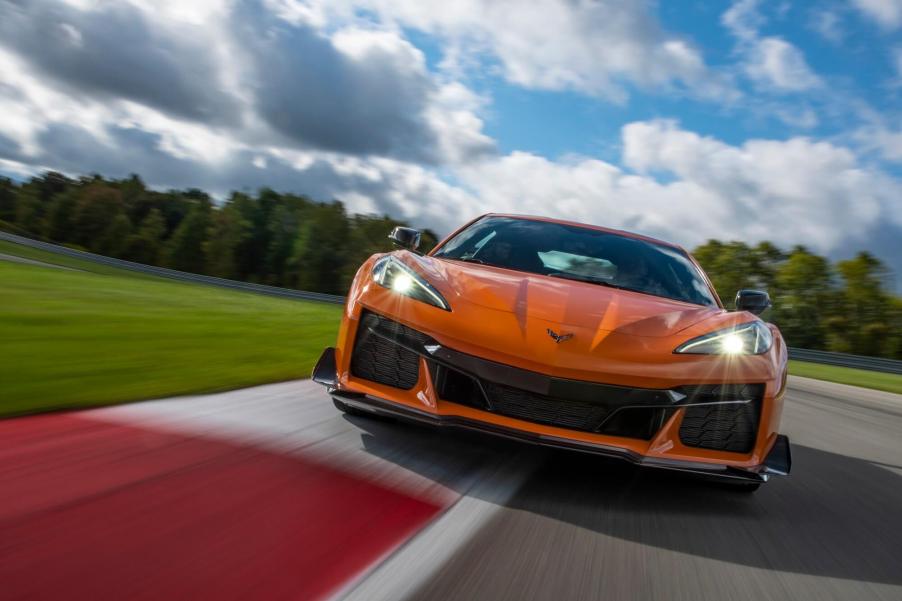 An orange 2023 Chevy Corvette Z06 takes a corner on the track.