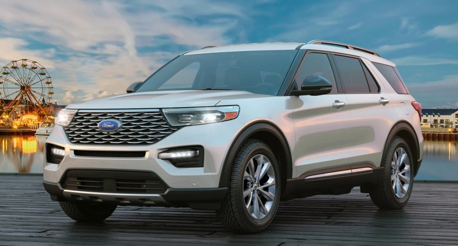 A white 2023 Ford Explorer midsize SUV is parked on a dock. 