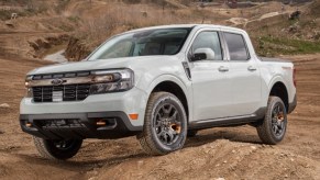 A gray 2023 Ford Maverick small pickup truck is driving off-road.