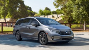 A gray 2023 Honda Odyssey minivan is parked.