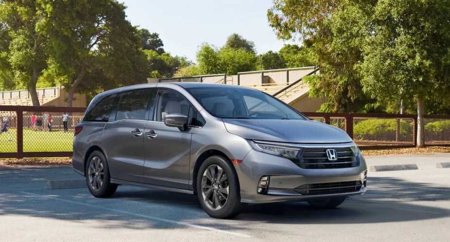 A gray 2023 Honda Odyssey minivan is parked. 