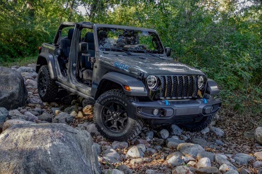 Gray entry-level Jeep Wrangler 4xe parked in the middle of a rocky off-road trail.