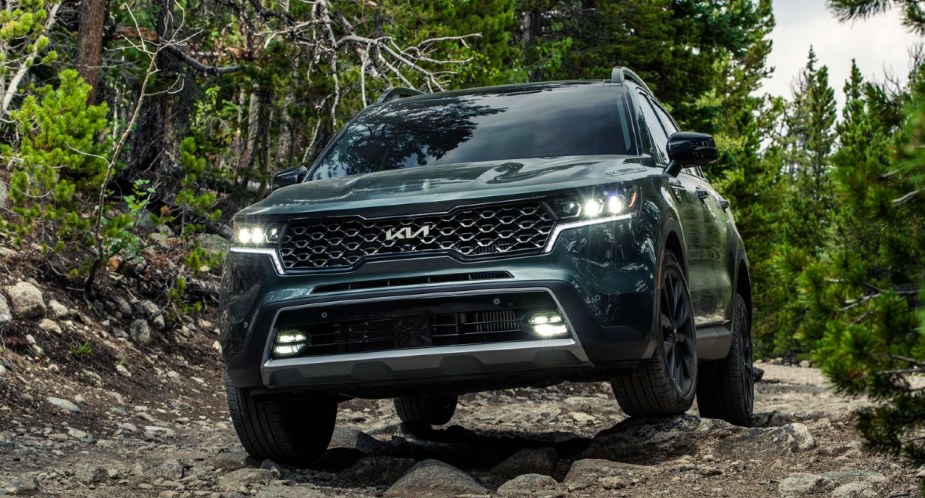 A green 2023 Kia Sorento X-Line is driving off-road. 