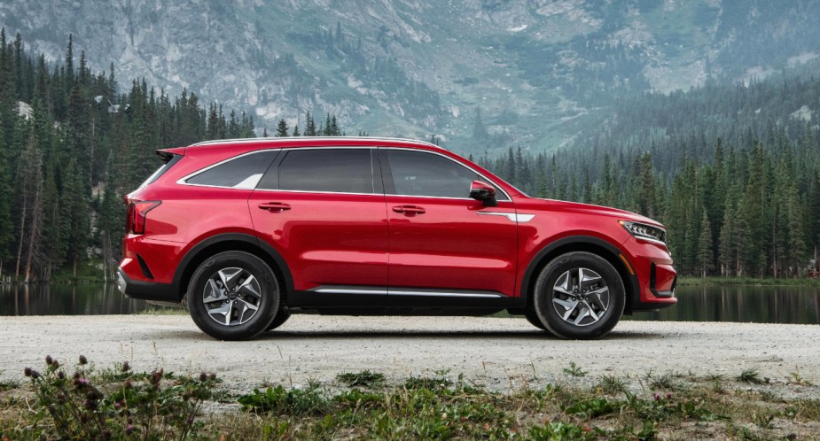 A red 2023 Kia Sorento Hybrid midsize hybrid SUV is parked. 