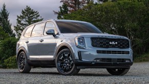 A gray 2023 Kia Telluride midsize SUV is parked outdoors.