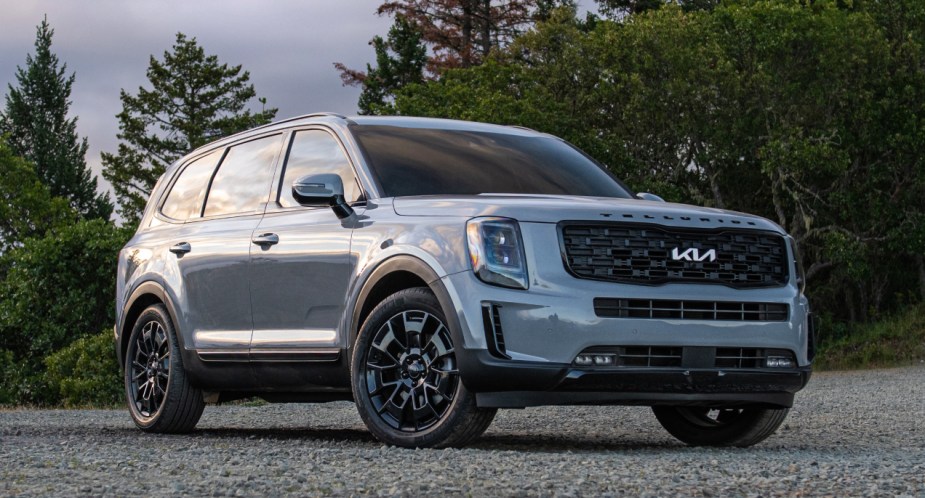 A gray 2023 Kia Telluride midsize SUV is parked outdoors. 