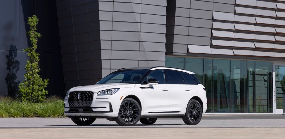 A white 2023 Lincoln Corsair parked in front of building. 