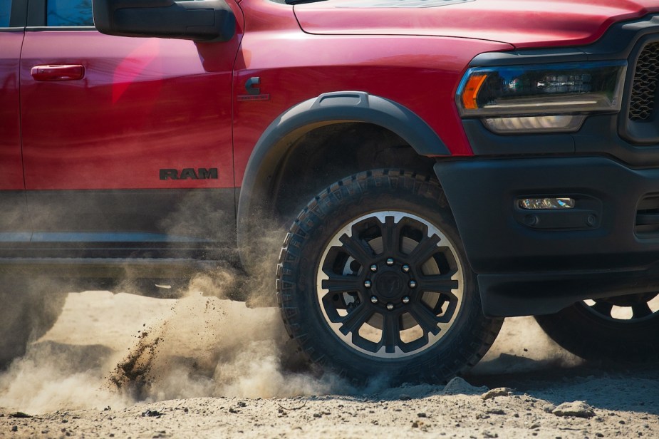 Closeup of a Cummins-powered Ram 2500 Rebel pickup truck's diesel badge and off-road tires.