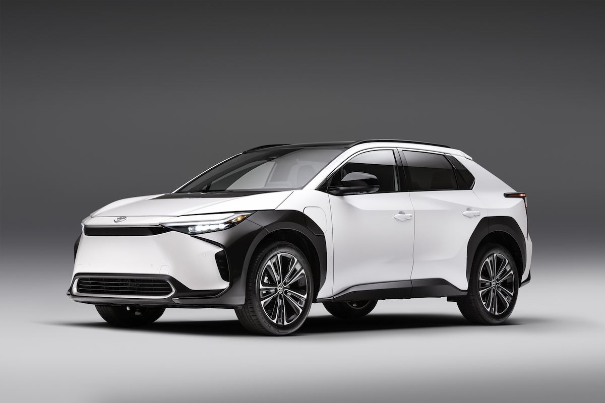 A white 2023 Toyota bZ4X parked in a white and black room. 