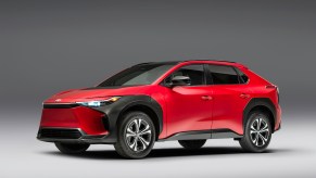 A red 2023 Toyota bZ4X parked in a black and white room.