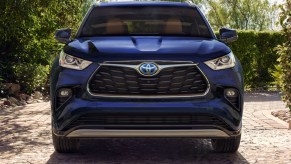 A blue 2023 Toyota Highlander Hybrid midsize SUV is parked.