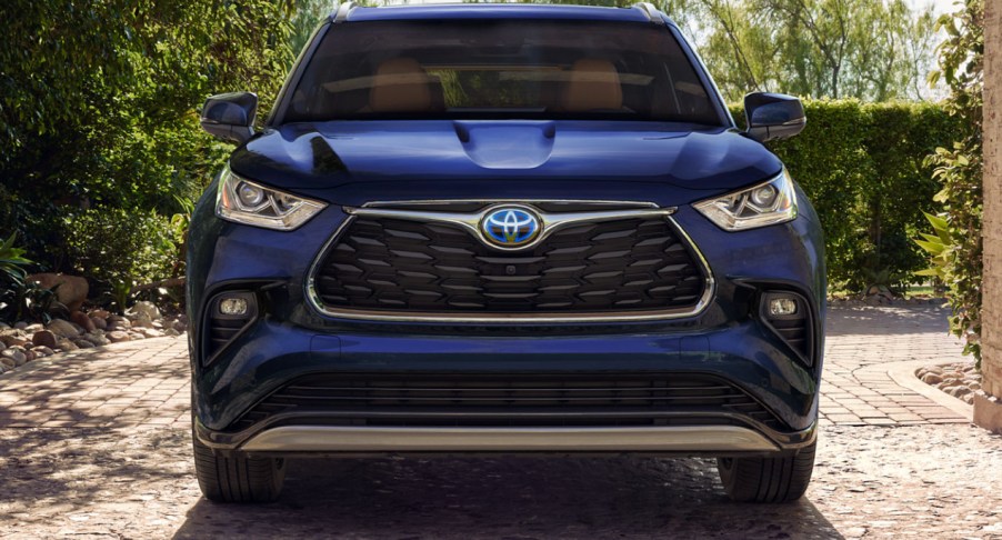 A blue 2023 Toyota Highlander Hybrid midsize SUV is parked.