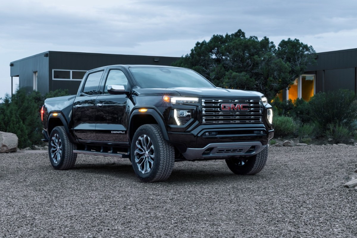 A black GMC Canyon parked in front of a house