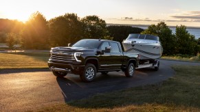 Front 3/4 view of the 2024 Chevrolet Silverado HD High Country towing a boat