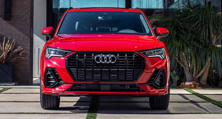 A red Audi Q3 luxury subcompact SUV is parked.