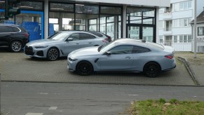 A BMW 4 Series in front of a dealership.