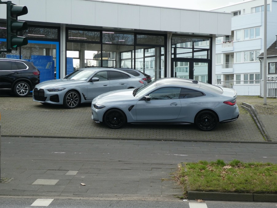 A BMW 4 Series in front of a dealership.