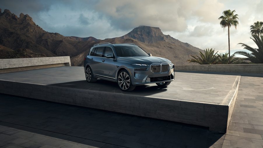 A silver 2023 BMW X7 drives on a road. What's new with the three-row SUV?