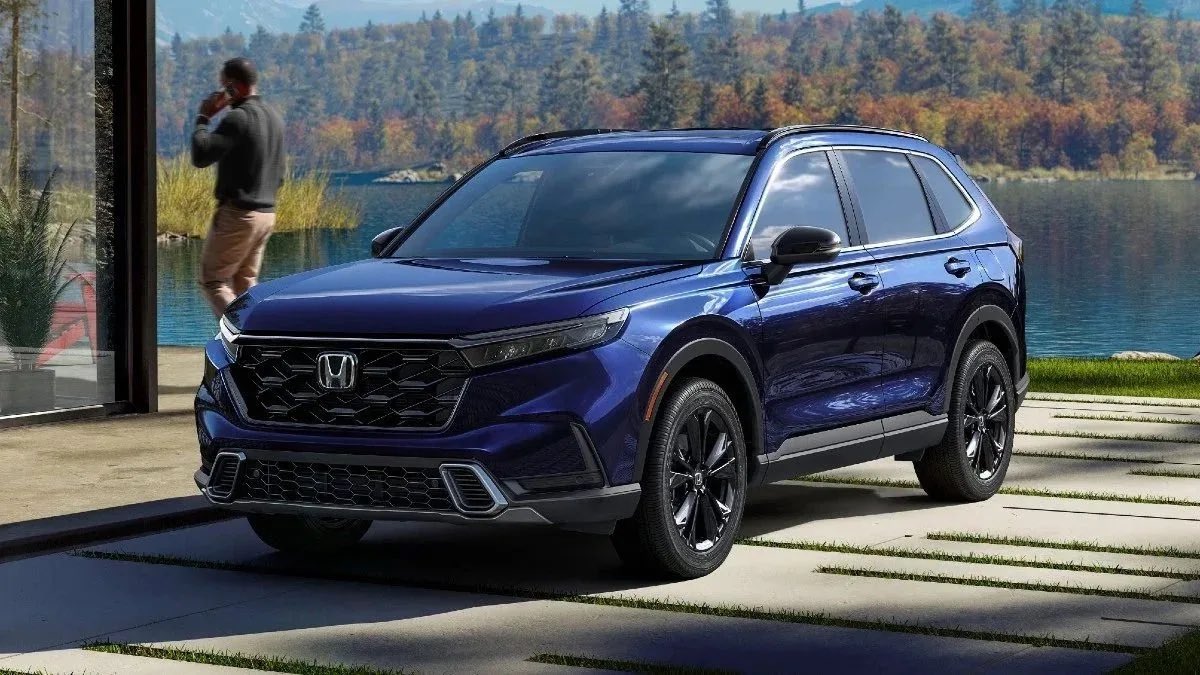 Blue 2023 Honda CR-V crossover SUV parked near a lake