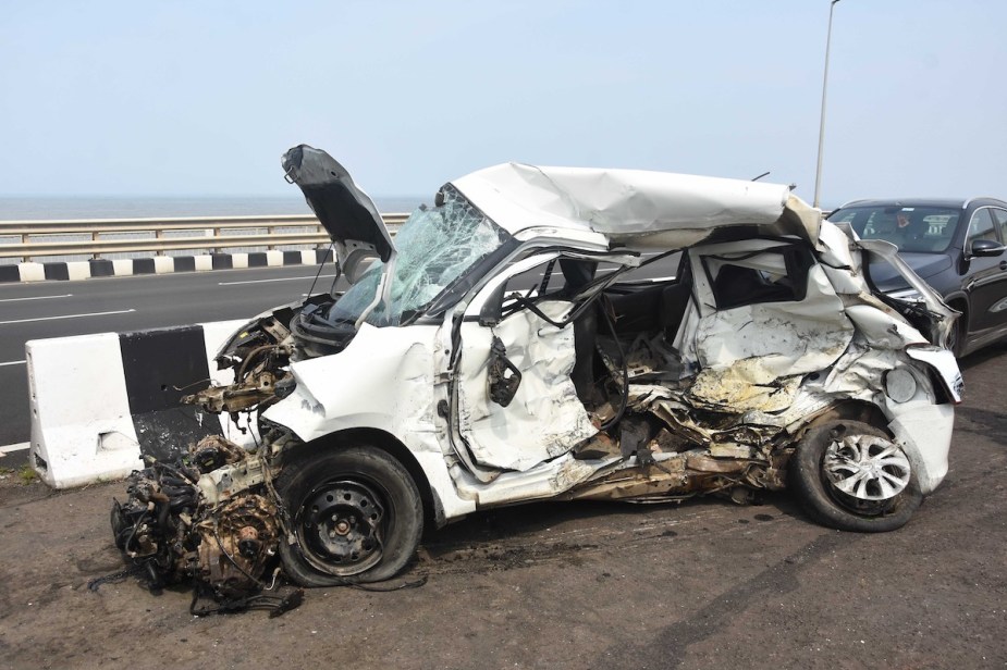 A white car involved in a car accident who hopefully knows what liability limit means. 