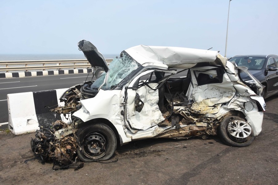 A white car involved in a car accident who hopefully knows what liability limit means.