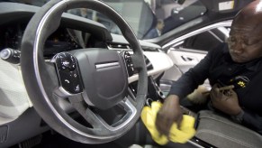 A person cleaning the interior of a car.