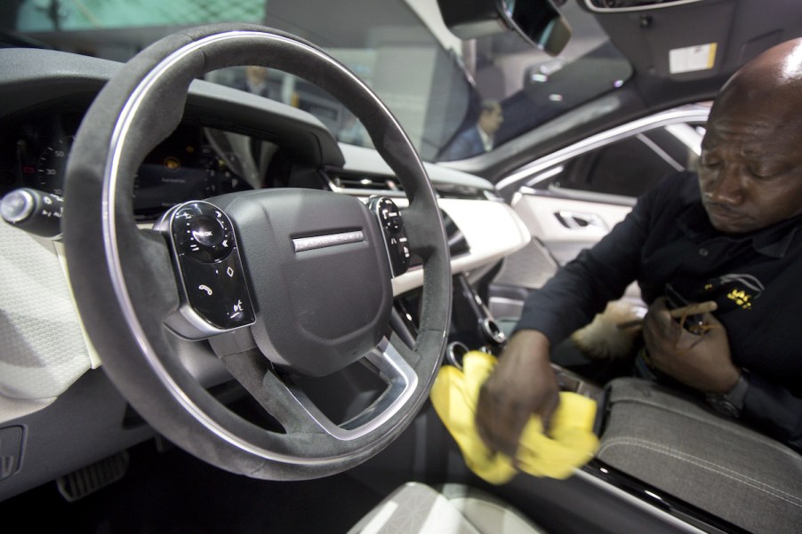 A person cleaning the interior of a car.