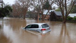 A silver VW car damaged in a flood