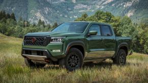 Front angle view of Tactical Green Metallic 2023 Nissan Frontier midsize pickup truck