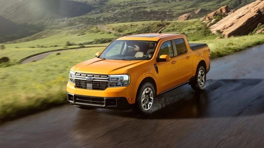 Front angle view of orange 2023 Ford Maverick, affordable Hyundai Santa Cruz pickup truck alternative costing under $28,000