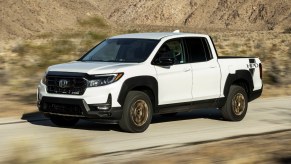 Front angle view of white 2023 Honda Ridgeline midsize pickup truck