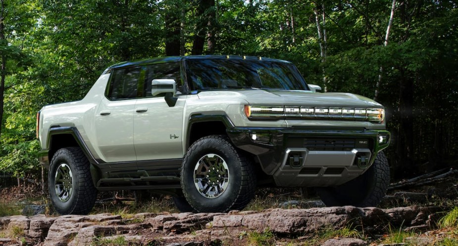 A gray GMC Hummer EV electric pickup truck is parked outdoors. 