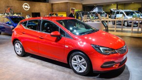 A red hatchback in a showroom.