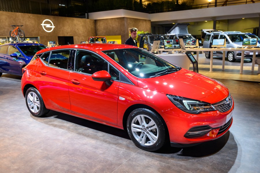 A red hatchback in a showroom.