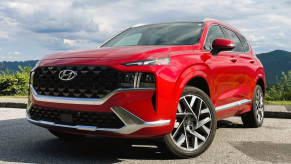 A red 2022 Hyundai Santa Fe parked on a scenic mountain road.