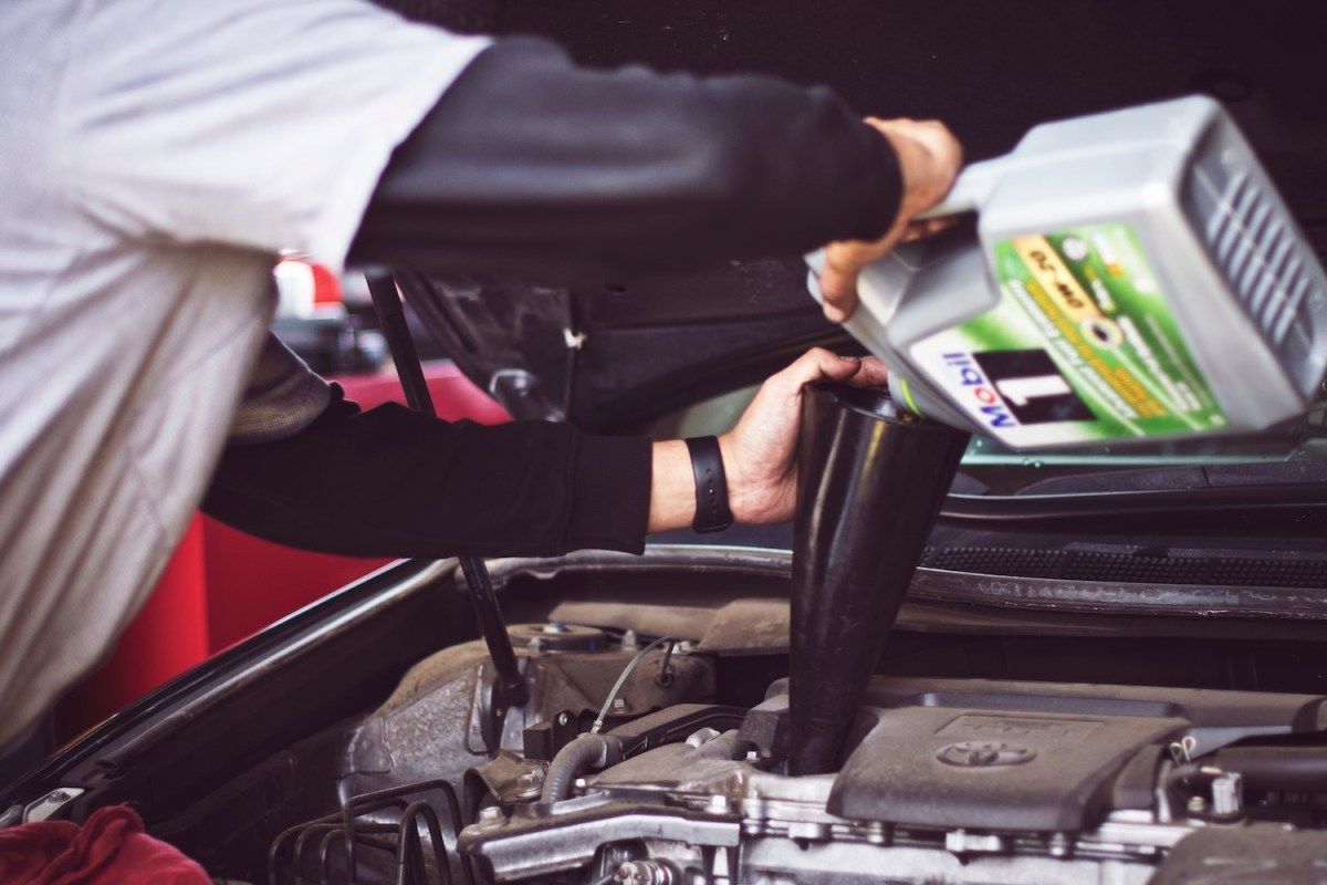 A mechanic conducting an oil change