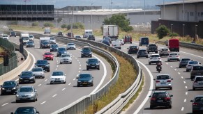 A group of people driving on a highway, potentially on the verger of aggressive driving.