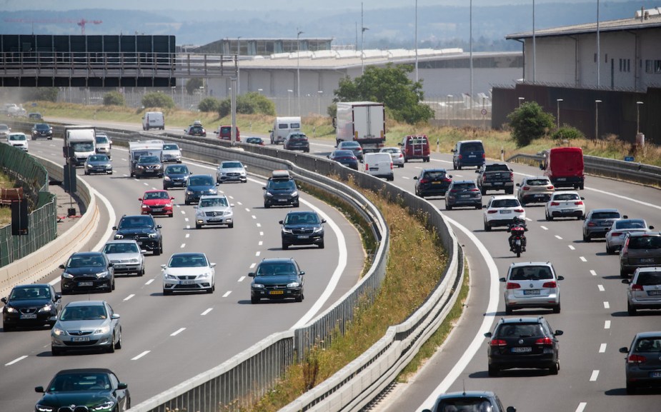 A group of people driving on a highway, potentially on the verger of aggressive driving. 