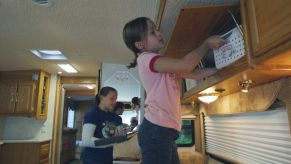 Stowing school supplies in RV storage compartments in Minnetonka, Minnesota