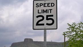 A 25 mph speed limit sign on the side of a road. Federal regulators want to limit your car's speed.