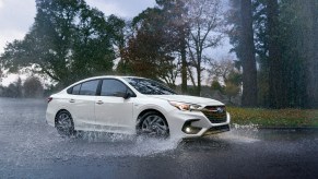 A fully loaded 2023 Subaru Legacy kicks up water with its standard Subaru AWD system.