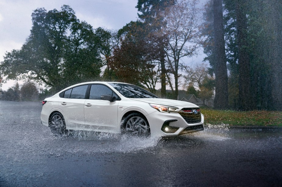 A fully loaded 2023 Subaru Legacy kicks up water with its standard Subaru AWD system. 