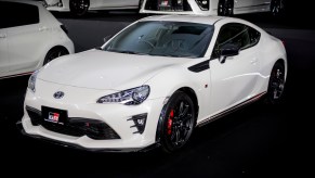 A white Toyota GR86 parked indoors.