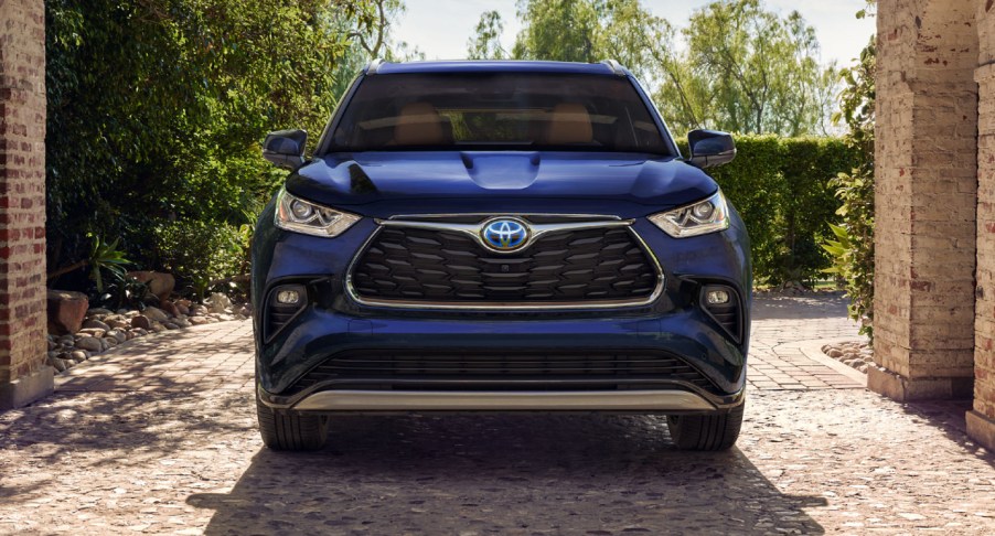 A blue 2023 Toyota Highlander Hybrid midsize hybrid SUV is parked.