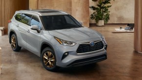 A gray 2023 Toyota Highlander Hybrid is parked indoors.