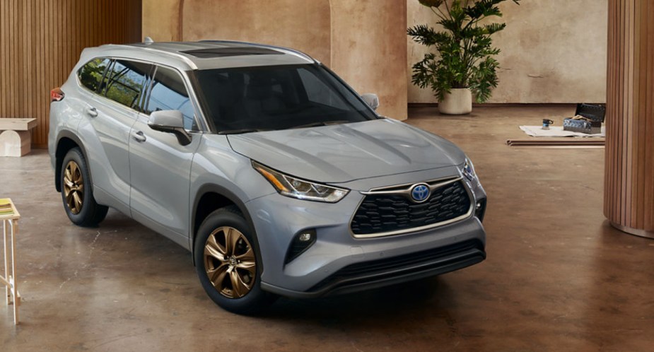 A gray 2023 Toyota Highlander Hybrid is parked indoors. 