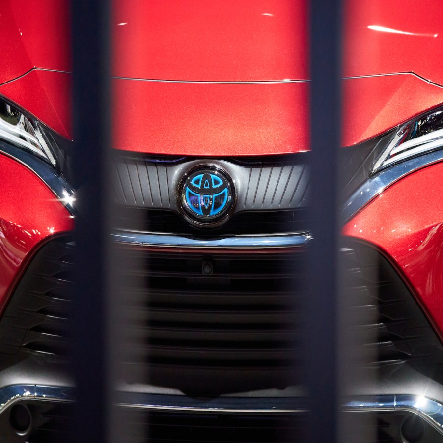 The front end of a red Toyota Prius.