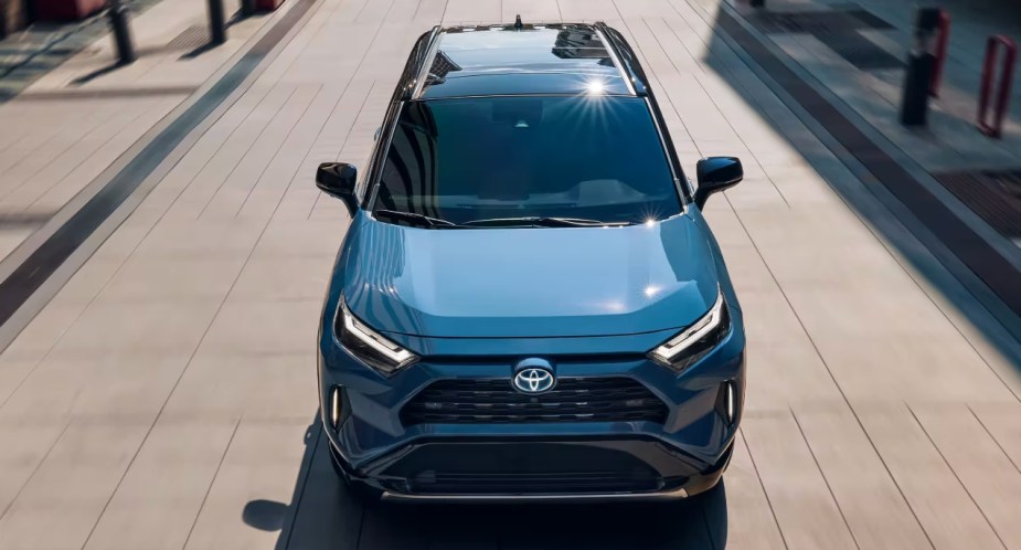 A blue 2022 Toyota RAV4 Hybrid small SUV is driving. 