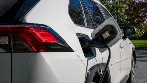 A white Toyota RAV4 Prime PHEV charging.