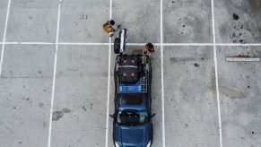 A 200 Series Land Cruiser sits in a parking lot, it has been converted for camping.